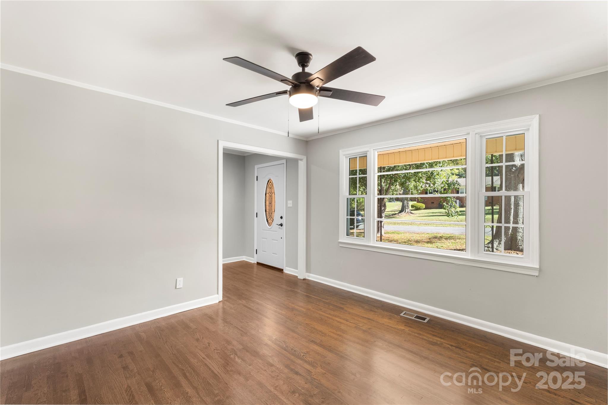 1428 Boxwood Avenue Lancaster, SC 29720 - Photo 14 of 44 a view of a livingroom with a window and a ceiling fan