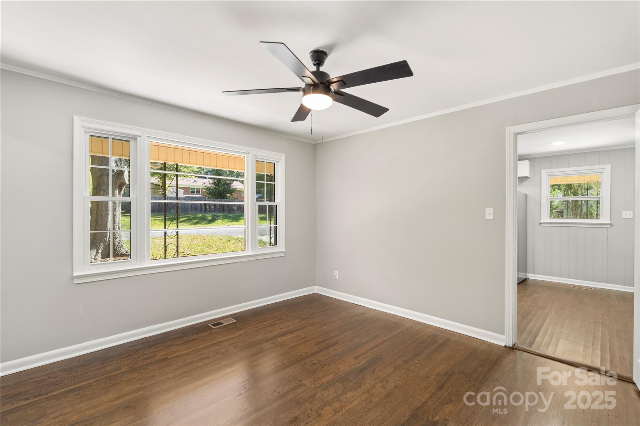 1428 Boxwood Avenue Lancaster, SC 29720 - Photo 15 of 44 an empty room with wooden floor fan and windows
