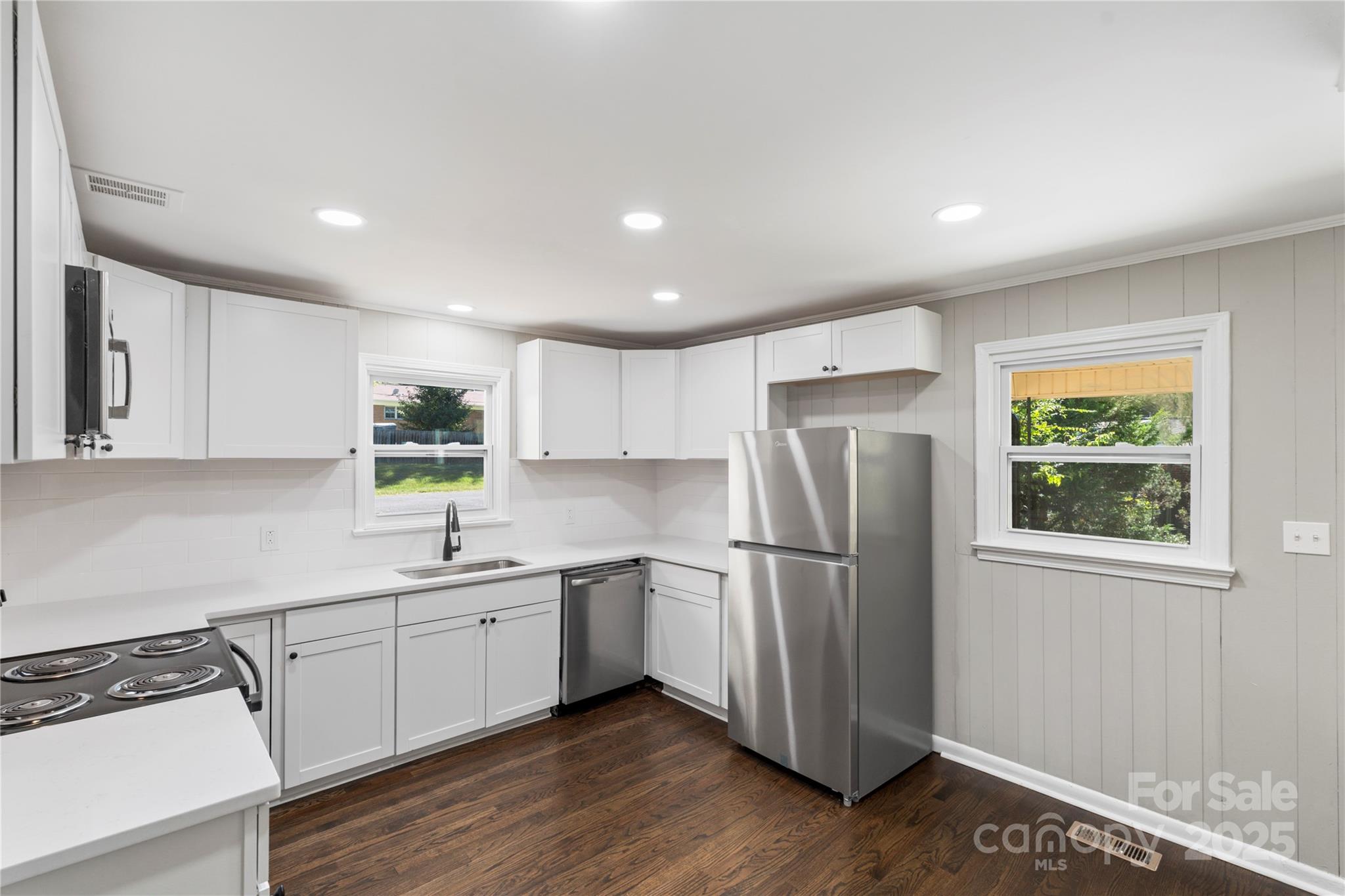 1428 Boxwood Avenue Lancaster, SC 29720 - Photo 17 of 44 a kitchen with stainless steel appliances granite countertop a refrigerator sink and wooden cabinets