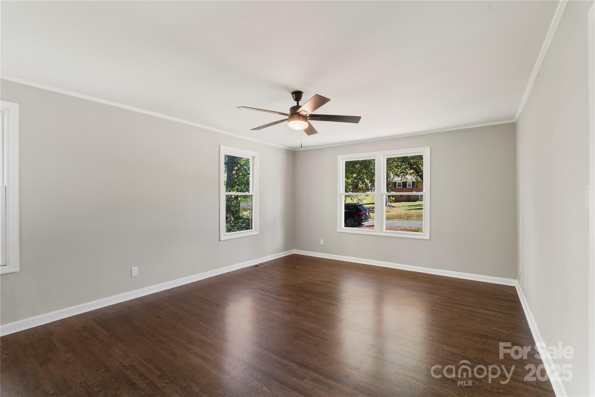 1428 Boxwood Avenue Lancaster, SC 29720 - Photo 23 of 44 an empty room with wooden floor and windows