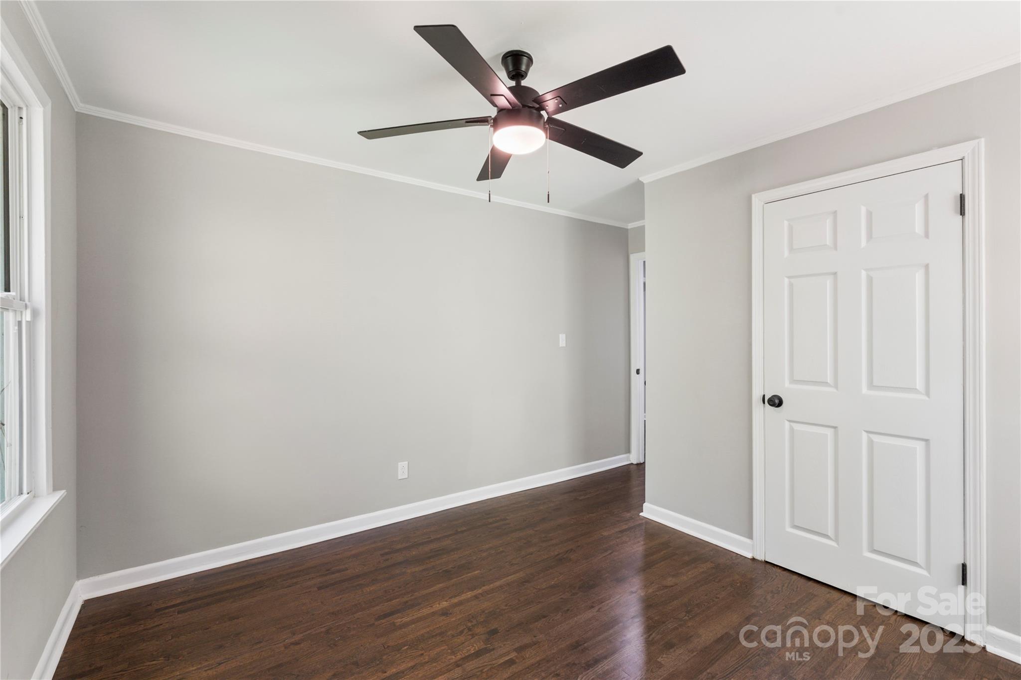 1428 Boxwood Avenue Lancaster, SC 29720 - Photo 28 of 44 an empty room with wooden floor and windows