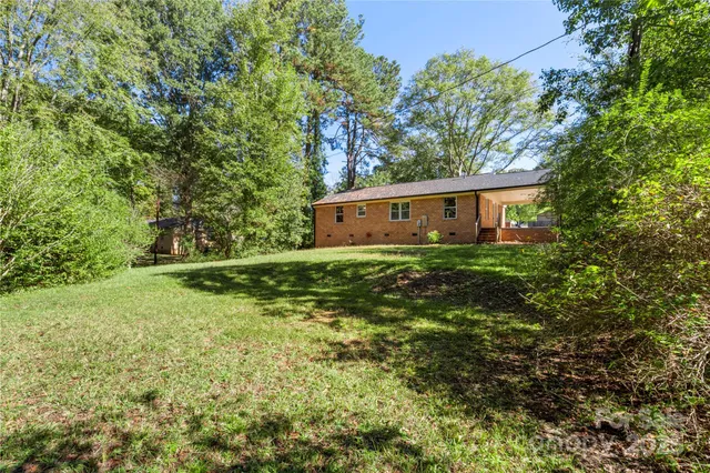 a view of house with yard and green space