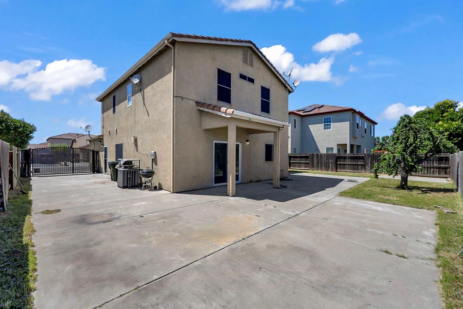 1412 Red Ribbons Lane Manteca, CA 95337 - Photo 17 of 32 a view of a house with a yard