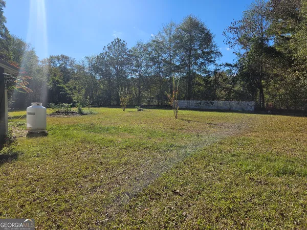 a view of outdoor space with deck and trees