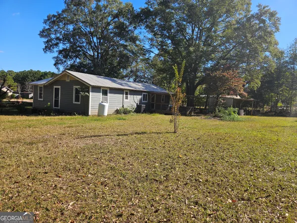 a house with a trees in the background