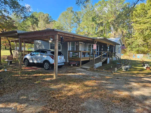 a backyard of a house with table and chairs