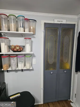 a view of a livingroom with furniture hardwood floor and a ceiling fan