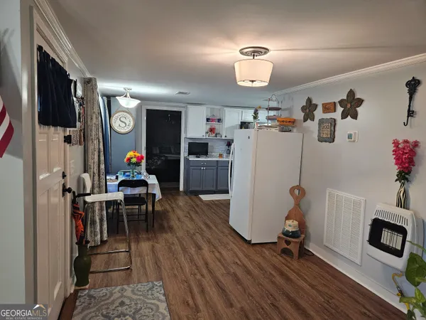 a living room with furniture potted plant and window