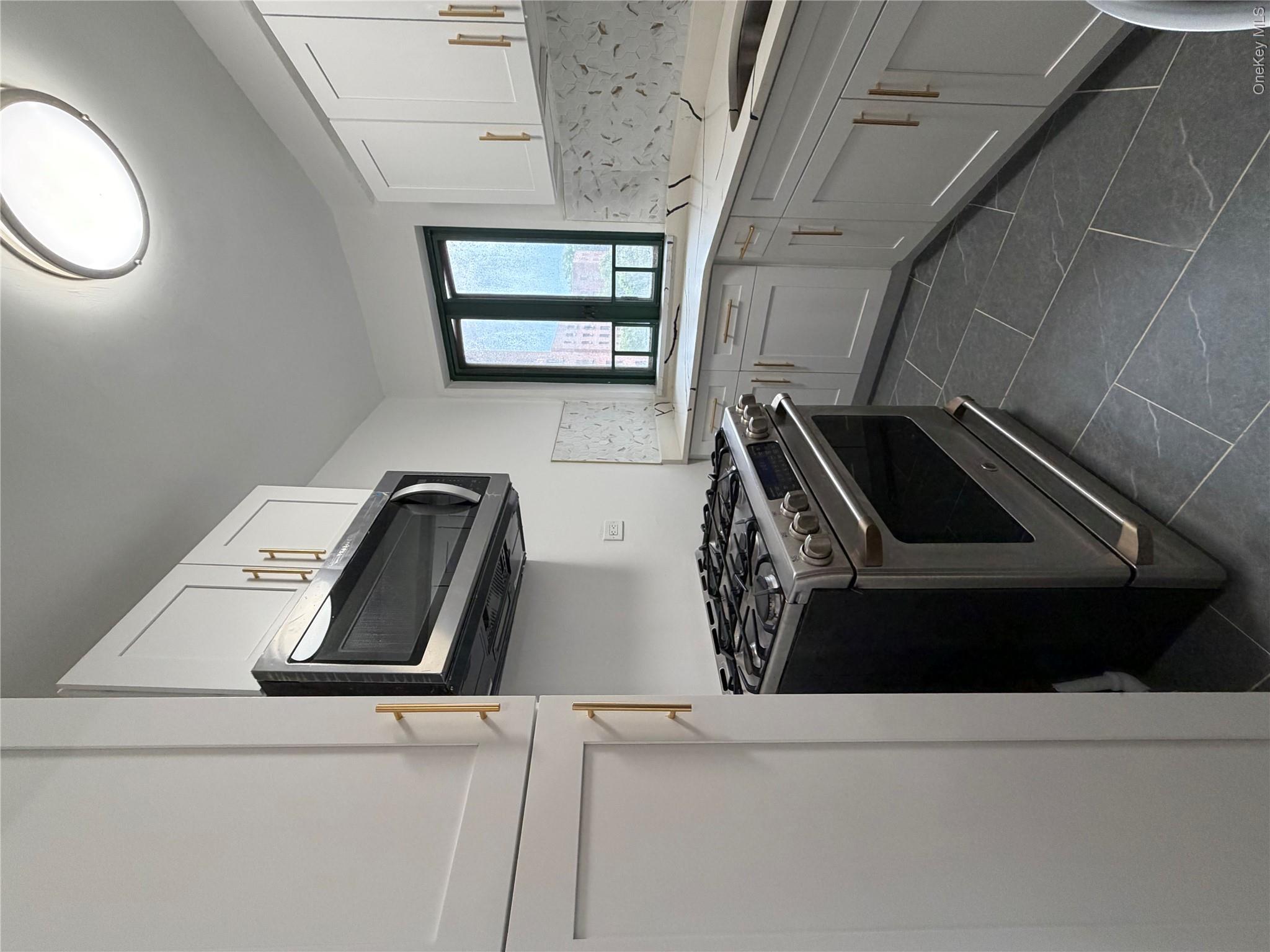 1503 Metropolitan Avenue, Unit 4F Bronx, NY 10462 - Photo 4 of 7 a kitchen with a stove and a sink