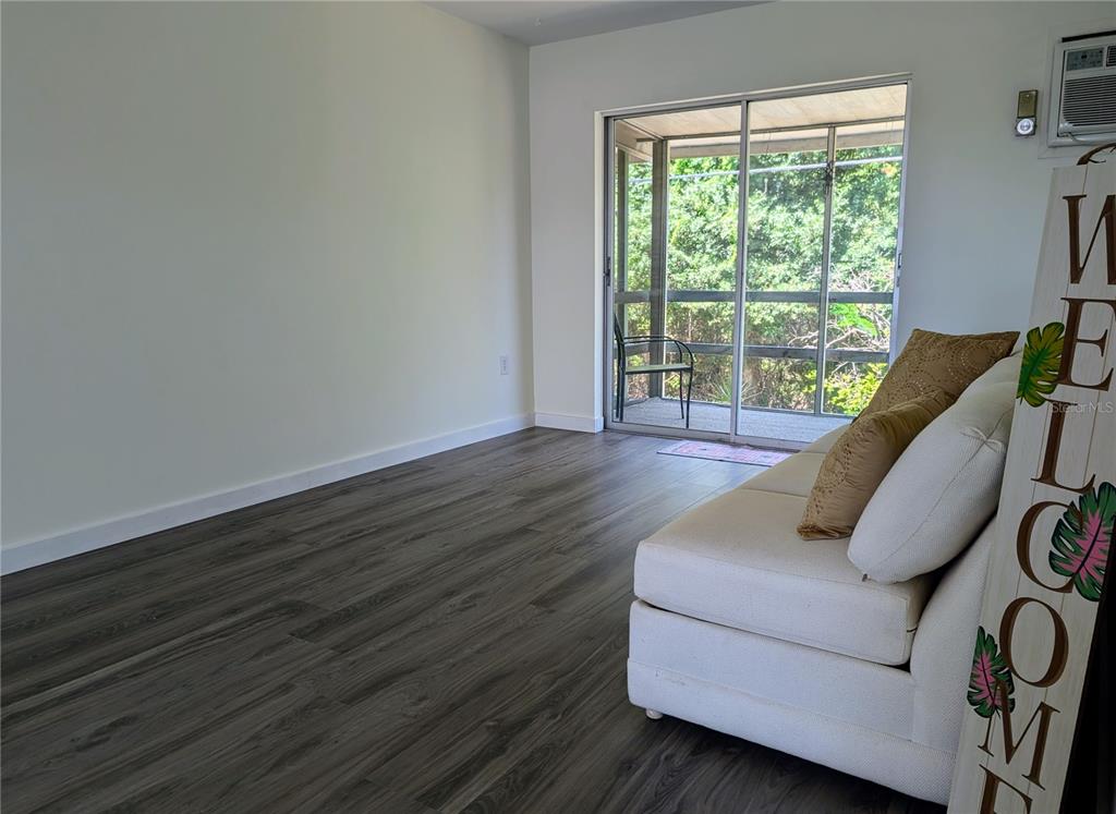5862 Welcome Road, Unit J25 Bradenton, FL 34207 - Photo 7 of 26 a living room with furniture and wooden floor