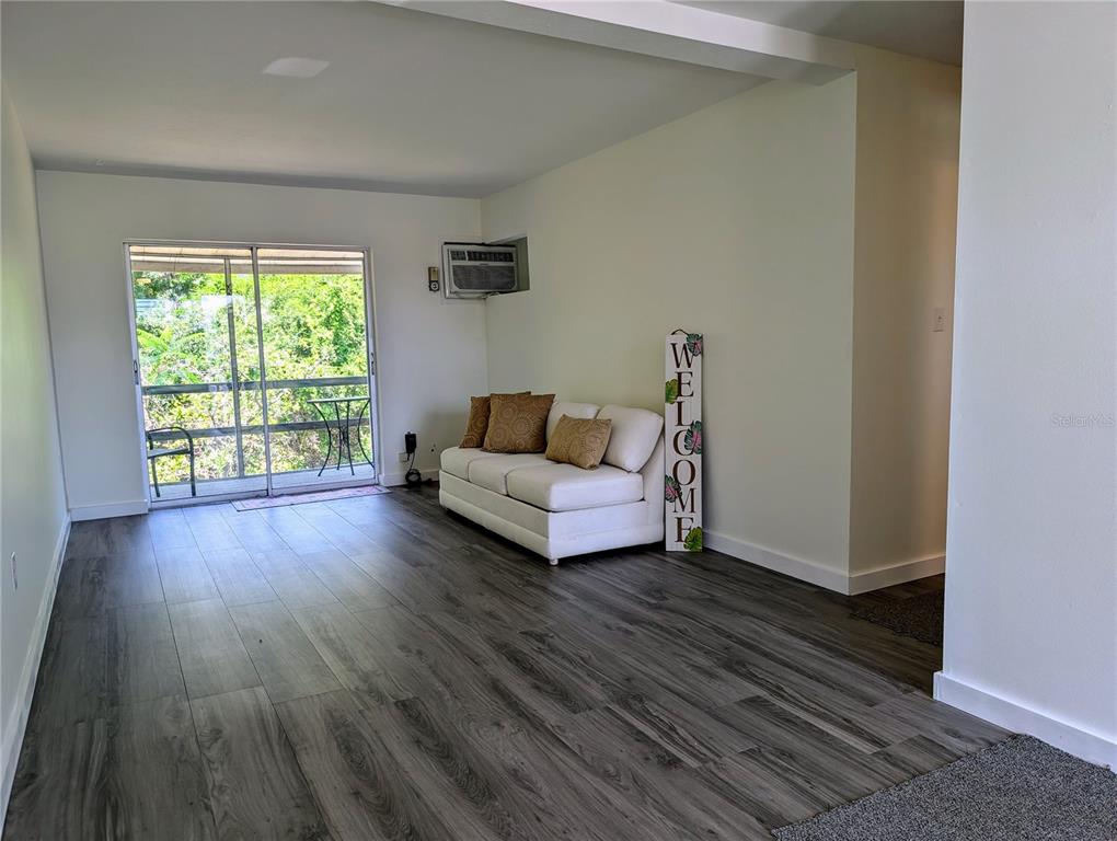 5862 Welcome Road, Unit J25 Bradenton, FL 34207 - Photo 8 of 26 a living room with furniture and a wooden floor