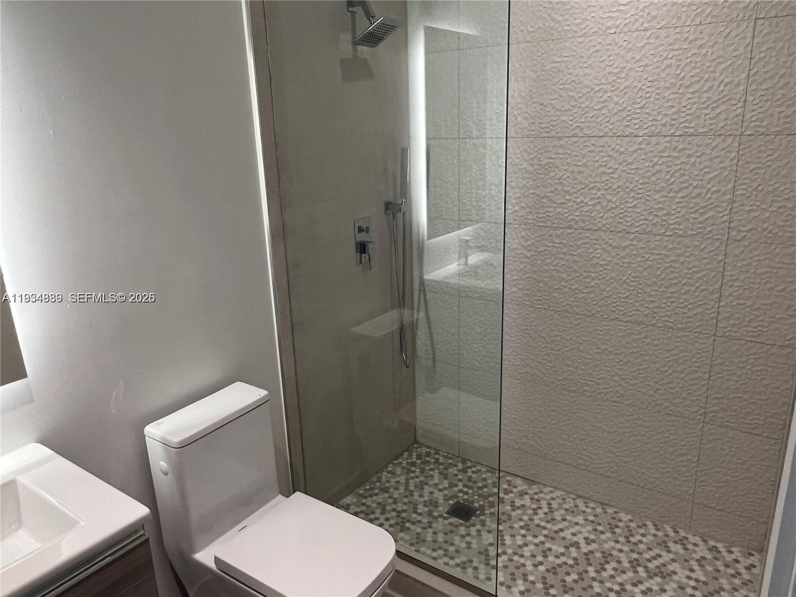 239 Southwest 9th Street, Unit 2103 Miami, FL 33130 - Photo 3 of 14 a bathroom with a toilet and a shower