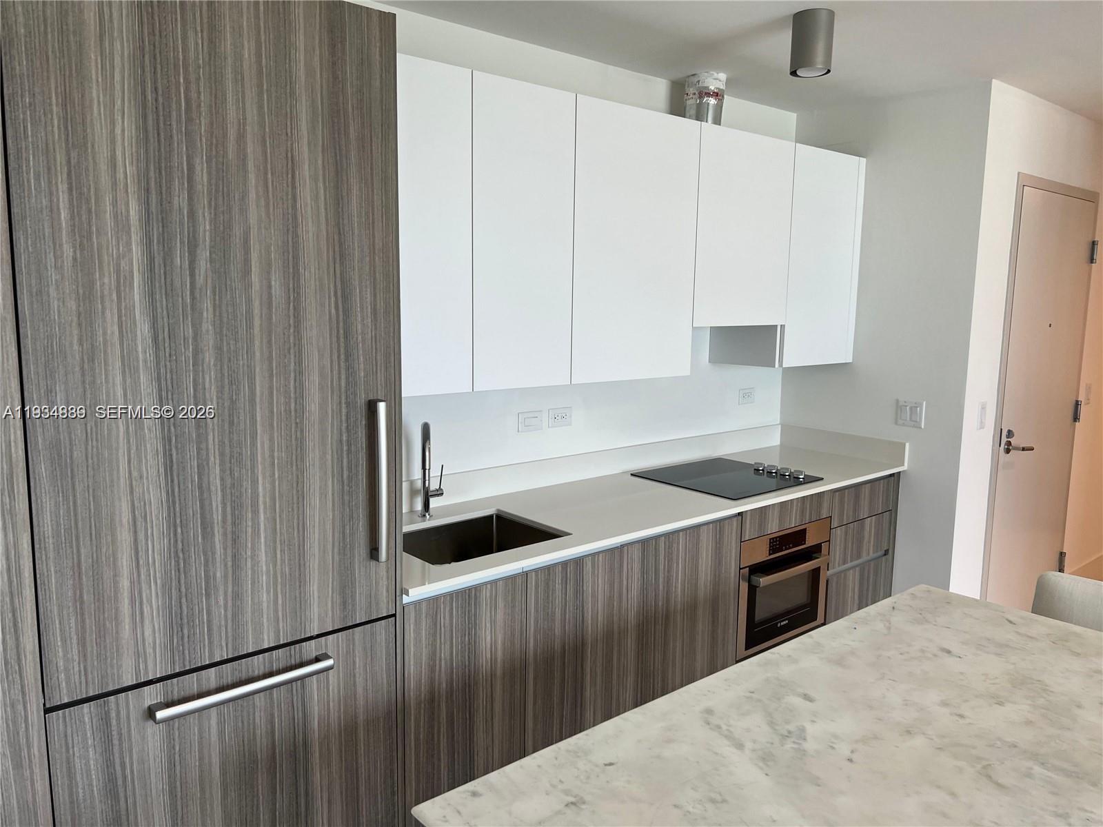 239 Southwest 9th Street, Unit 2103 Miami, FL 33130 - Photo 7 of 14 a kitchen with stainless steel appliances a refrigerator and a stove