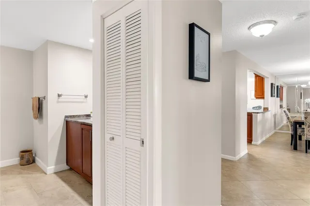 a view of a hallway with bathroom and a bathroom
