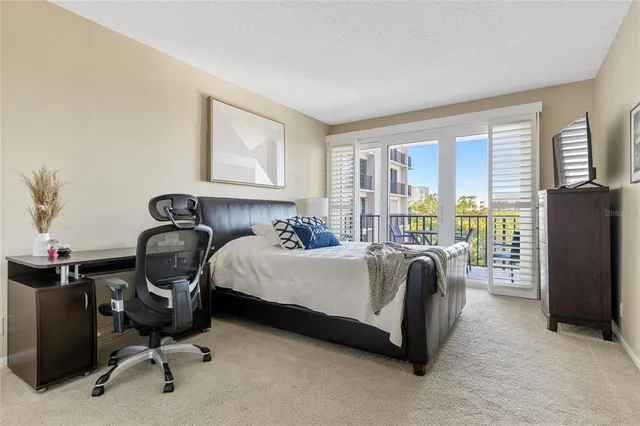 a bedroom with bed and glass door