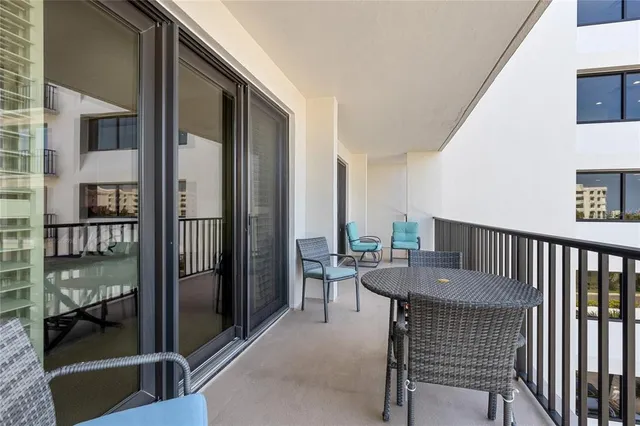 a dining room with furniture and a floor to ceiling window