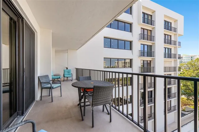 a view of a balcony with chairs