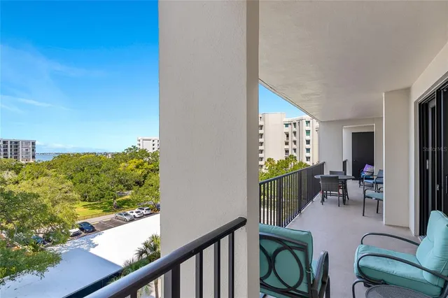a view of a chairs and table in a balcony