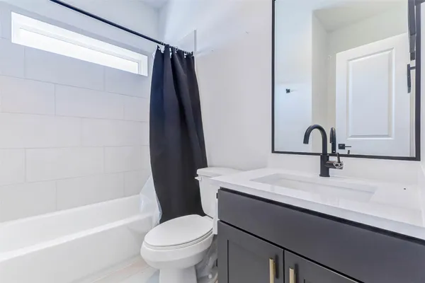 a bathroom with a double vanity sink a mirror and shower