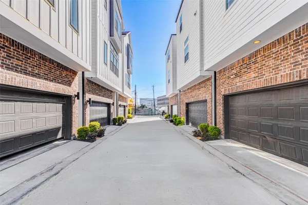 a view of a street with potted plants