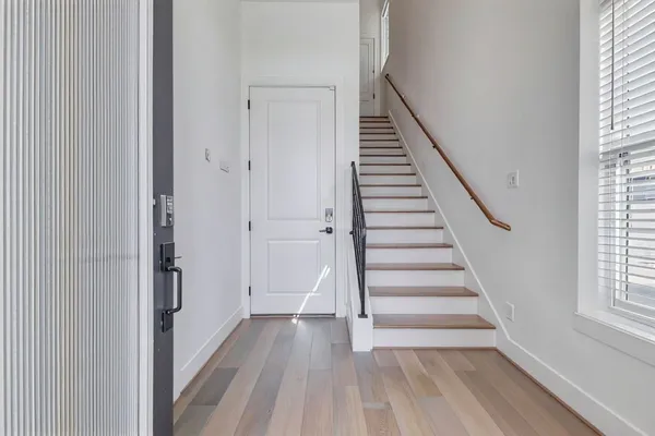 a view of entryway with wooden floor and stairs