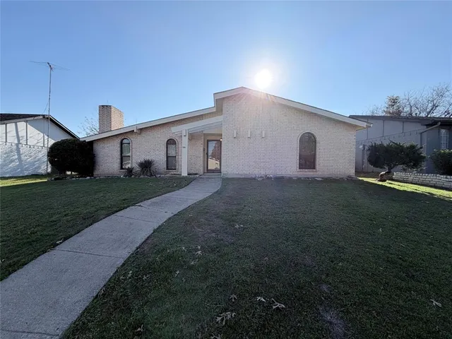 a house view with a sitting space fire pit and outdoor space