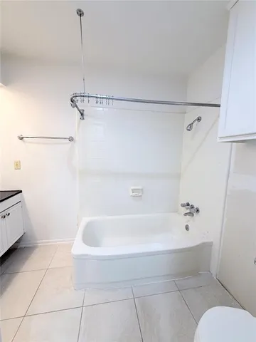 a bathroom with a bathtub and toilet