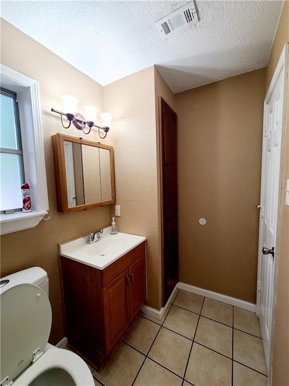 6702 Everhart Road Corpus Christi, TX 78413 - Photo 9 of 14 a bathroom with a sink a toilet and mirror