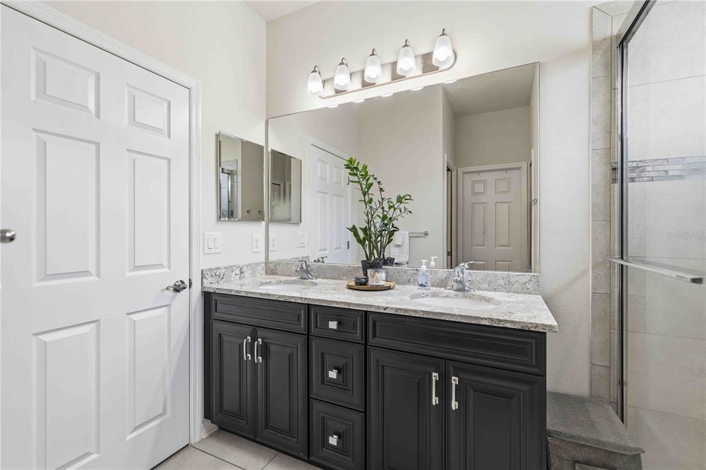 10920 79th Street East Parrish, FL 34219 - Photo 37 of 73 a bathroom with a double vanity sink and mirror