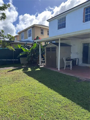 a view of a house with a yard porch and sitting area
