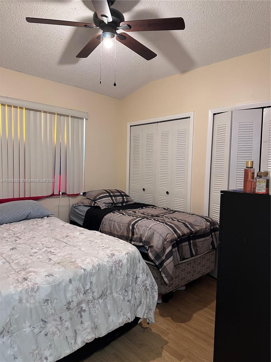 16215 Southwest 139th Court Miami, FL 33177 - Photo 23 of 31 a bedroom with two beds and a chandelier