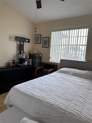 a bedroom with a bed and dresser