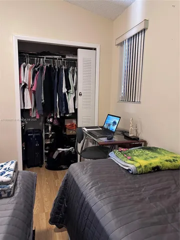 a bed room with two bed and a chair