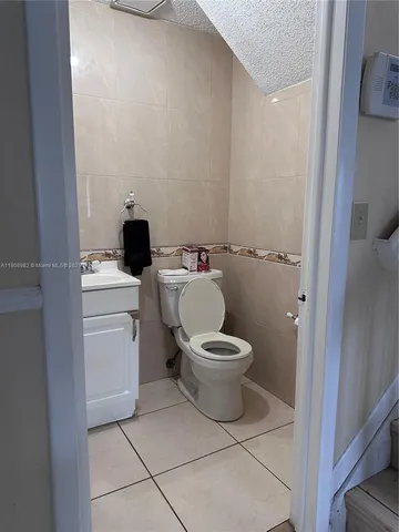 a white toilet sitting next to a bathroom sink