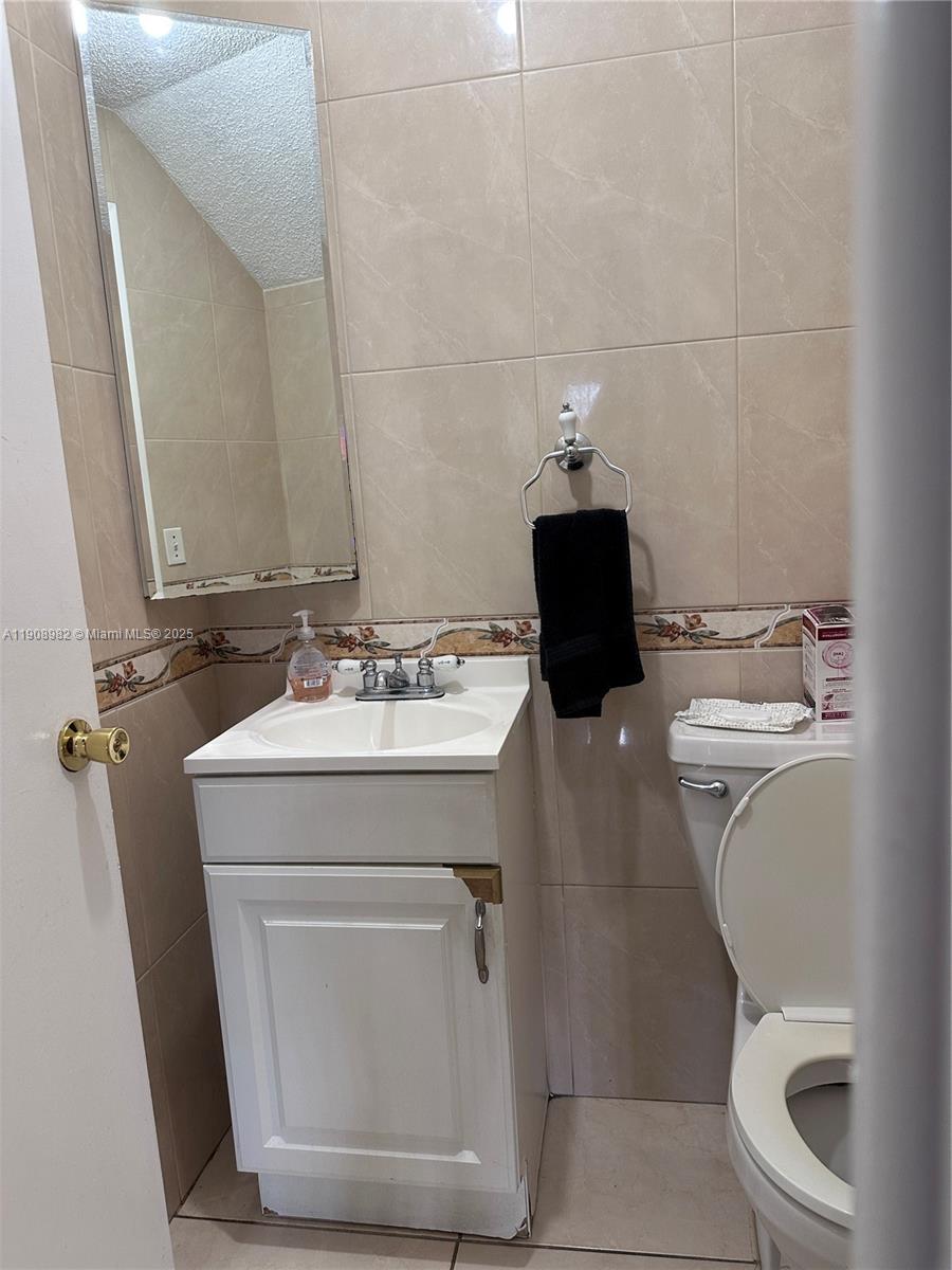 16215 Southwest 139th Court Miami, FL 33177 - Photo 28 of 31 a bathroom with a sink toilet and mirror