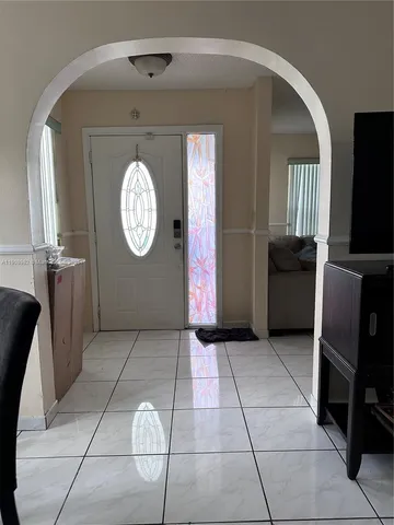a view of a livingroom with furniture and a window