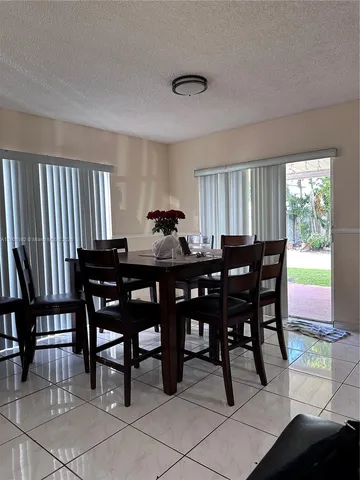 a view of a dining room with furniture and window