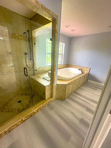 a bathroom with a tub a sink and shower