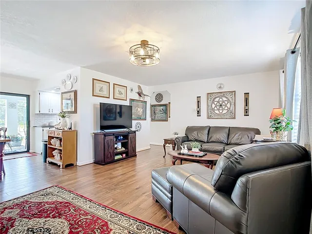 a view of a dining room with furniture and wooden floor