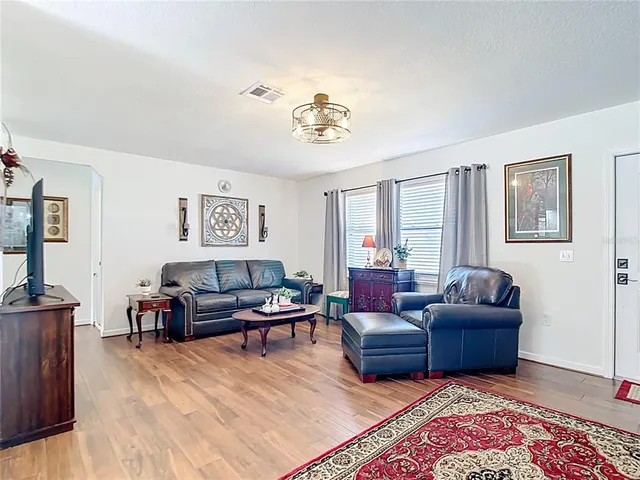 a view of a dining room with furniture and chandelier