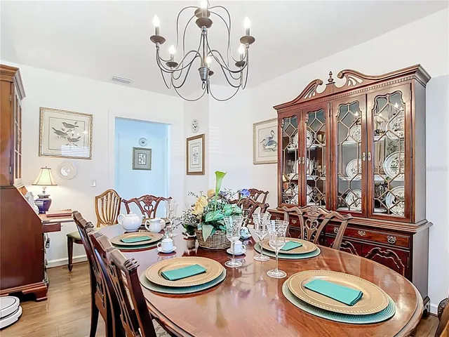 a bedroom with a bed and a lamp on dresser
