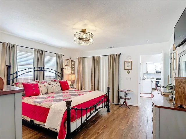 a view of a hallway with wooden floor and closet