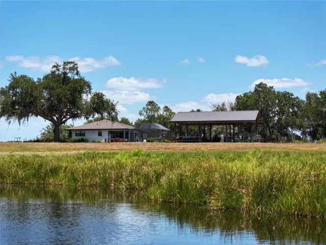 a view of a house with a yard and sitting area
