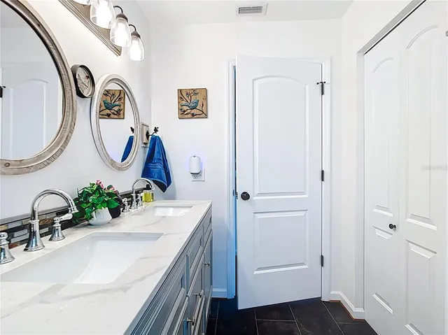 an aerial view of house with yard and ocean view