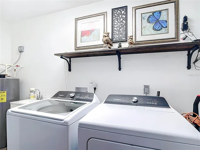 a view of a swimming pool with an outdoor seating and a lots of trees