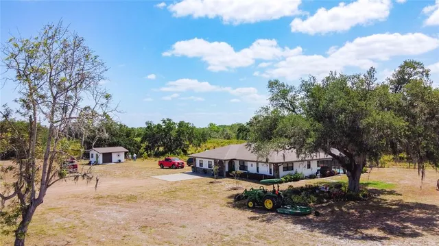 an aerial view of a house with a yard