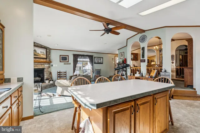 a dining hall with stainless steel appliances granite countertop a stove and a sink