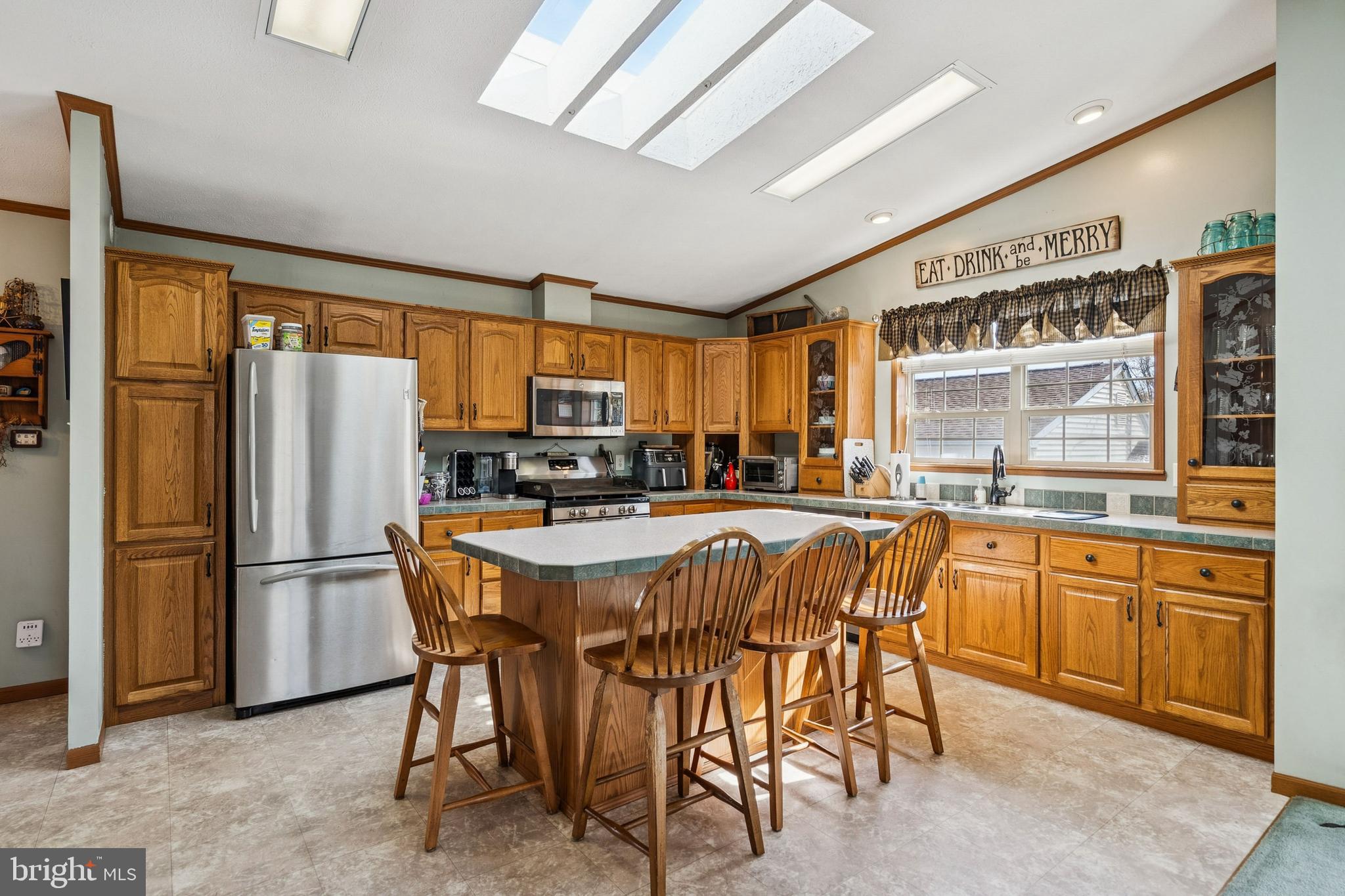 133 Spring Garden Street Woodstown, NJ 08098 - Photo 12 of 50 a dining room with stainless steel appliances granite countertop a refrigerator a stove a sink dishwasher a dining table and chairs with wooden floor