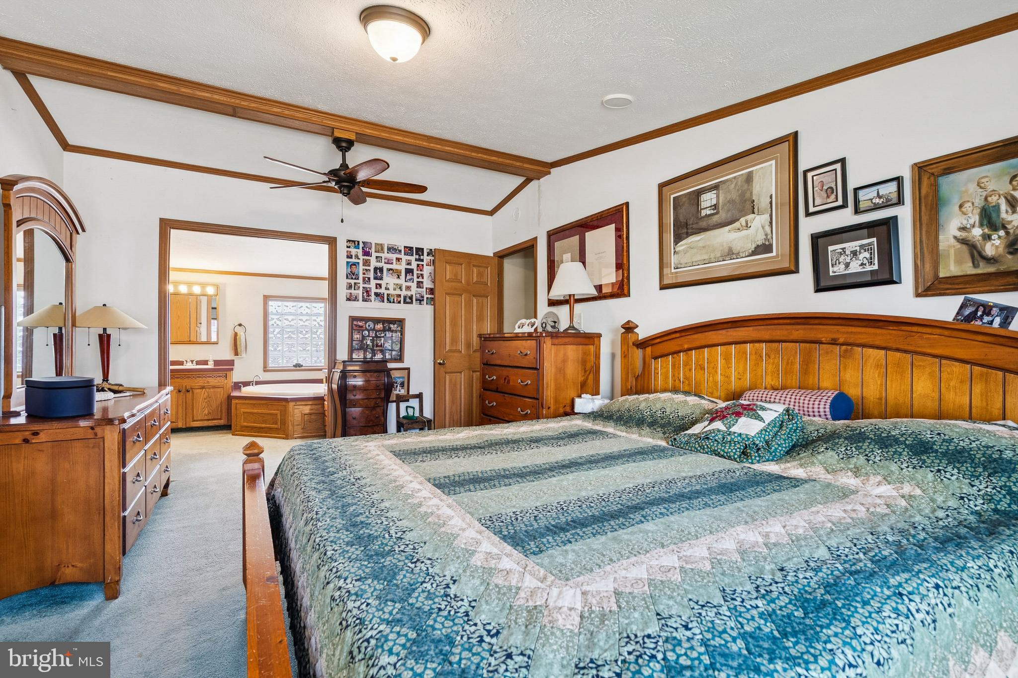 133 Spring Garden Street Woodstown, NJ 08098 - Photo 16 of 50 a bedroom with a large bed and ceiling fan