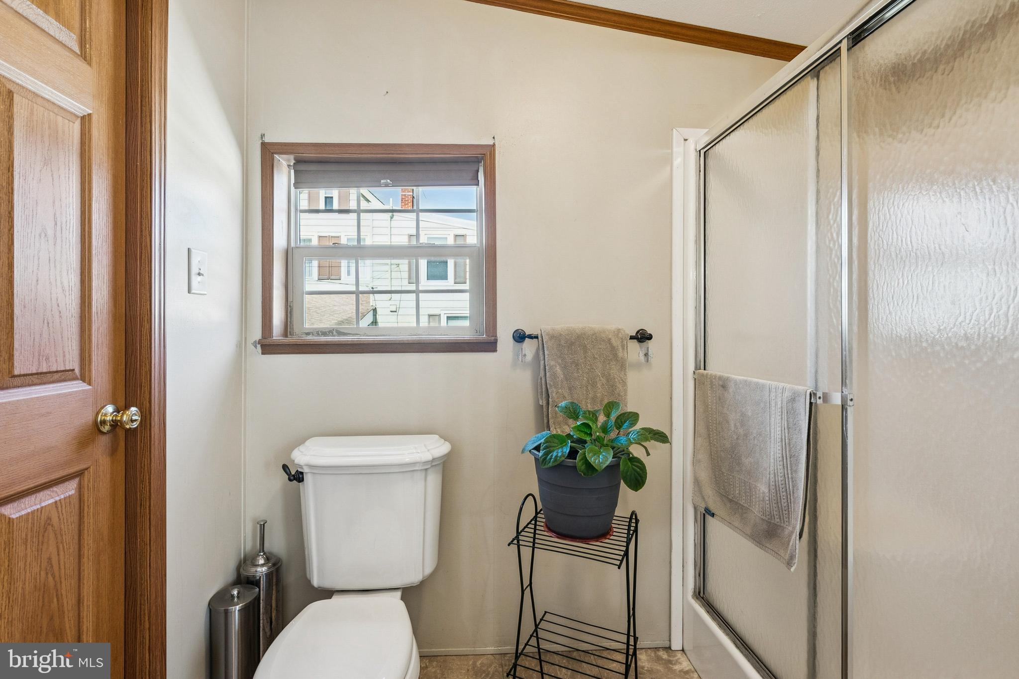 133 Spring Garden Street Woodstown, NJ 08098 - Photo 21 of 50 a white toilet sitting next to a bathroom and a shower